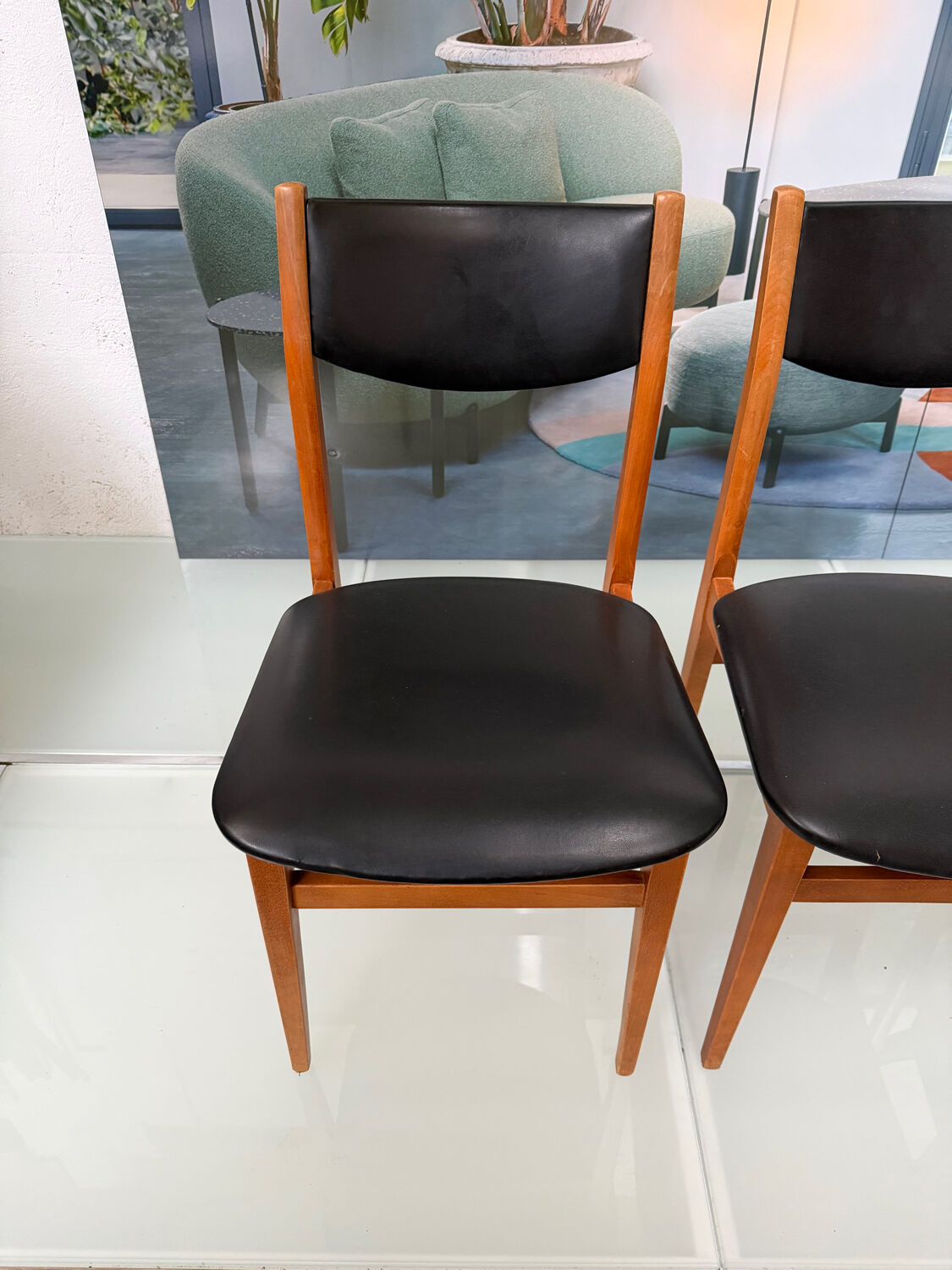 4 Scandinavian chairs in teak and black faux leather.
