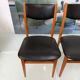 4 Scandinavian chairs in teak and black faux leather.