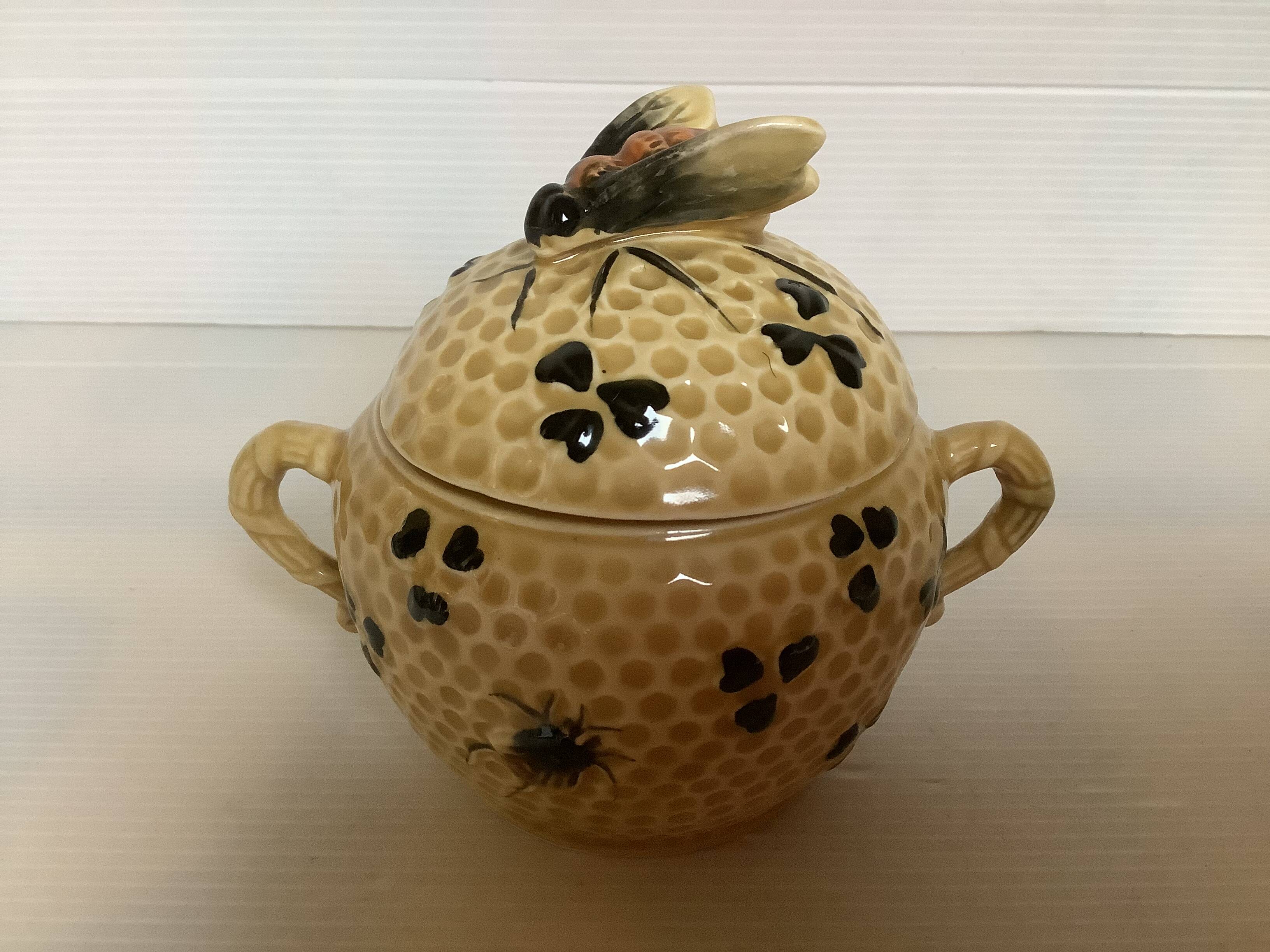 Old honey pot with bee decoration