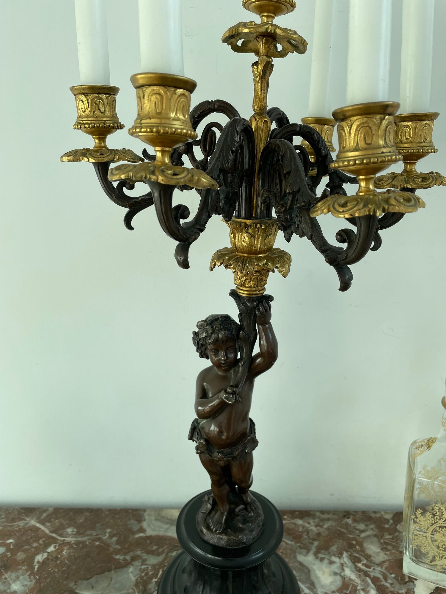Candelabra with cherub in patinated bronze