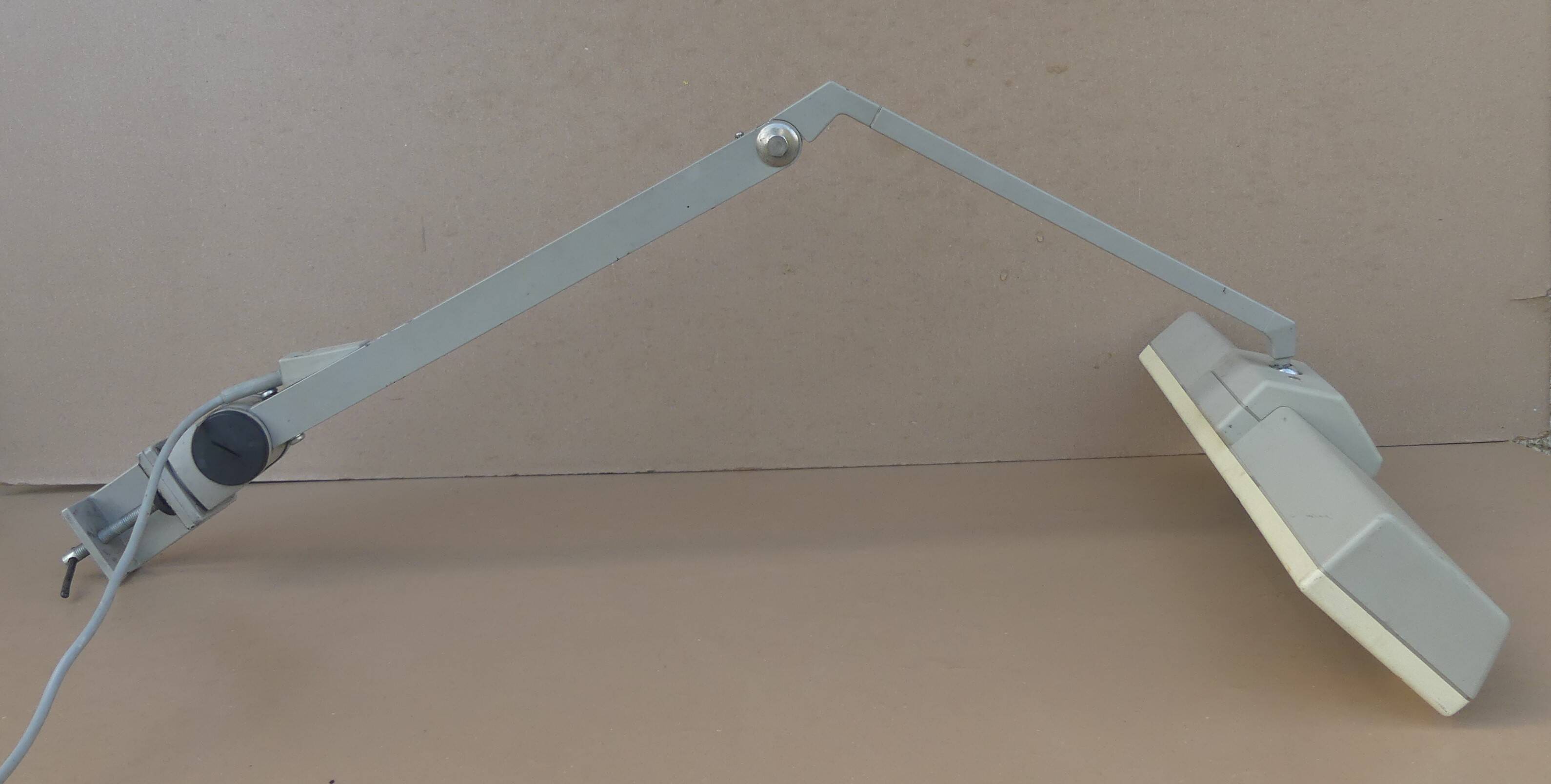 WALDMANN articulated workshop lamp with two industrial clamp arms for architects.