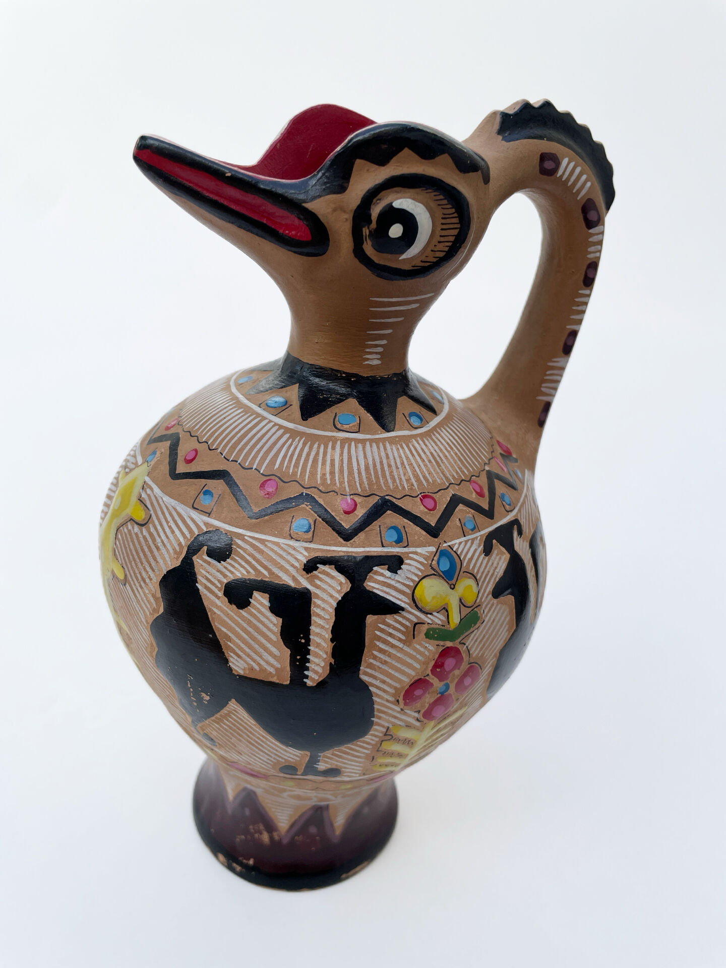 Clay pitcher with a bird head