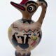Clay pitcher with a bird head