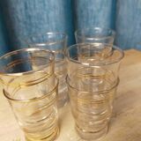 Set of 9 old glasses with golden net