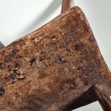 Rustic Wabi-Sabi style accent chair in dark curved hardwood, 1900s.