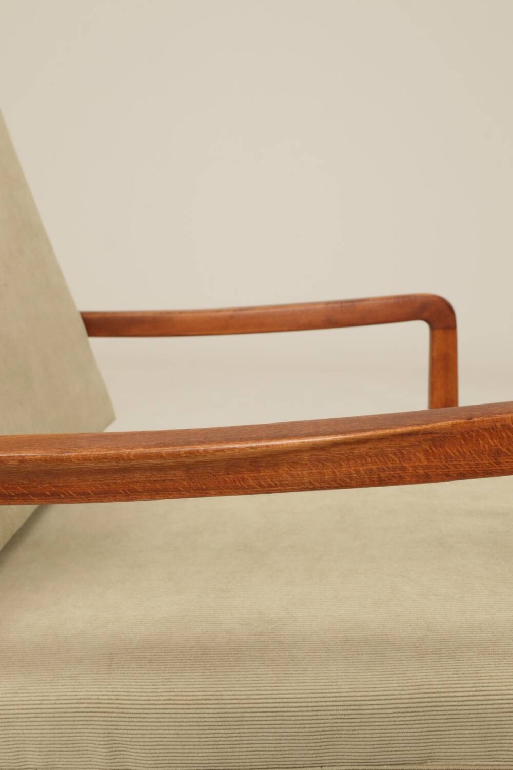 Vintage armchair in olive corduroy with a wooden frame.