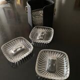 6 individual ashtrays in a leather case