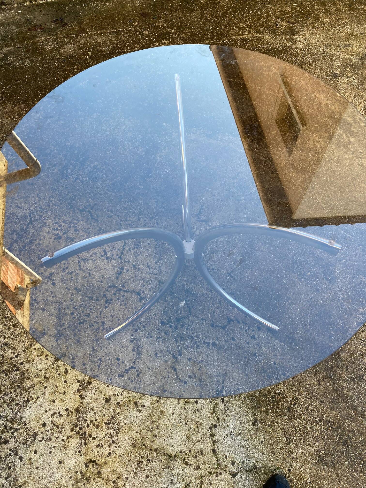 Table with chrome metal legs and smoked glass top.