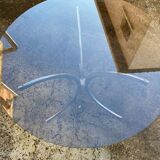 Table with chrome metal legs and smoked glass top.