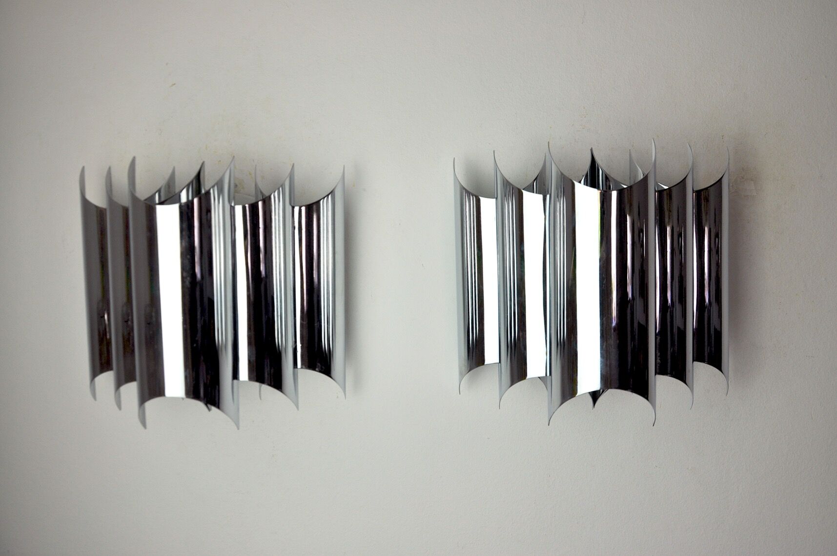 Pair of Raak wall lamps, space-age chrome design, Germany, 1970