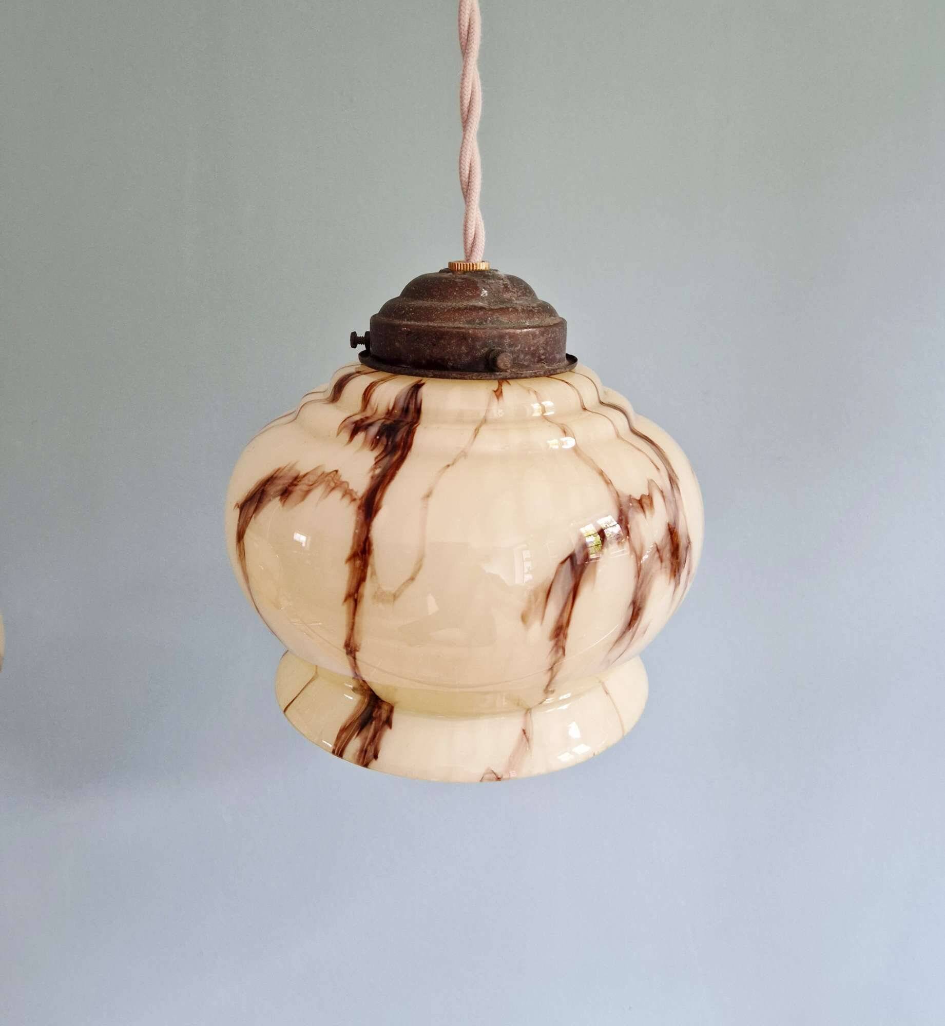 Trio of Art Deco marbled opaline pendant lights, 1920-30
