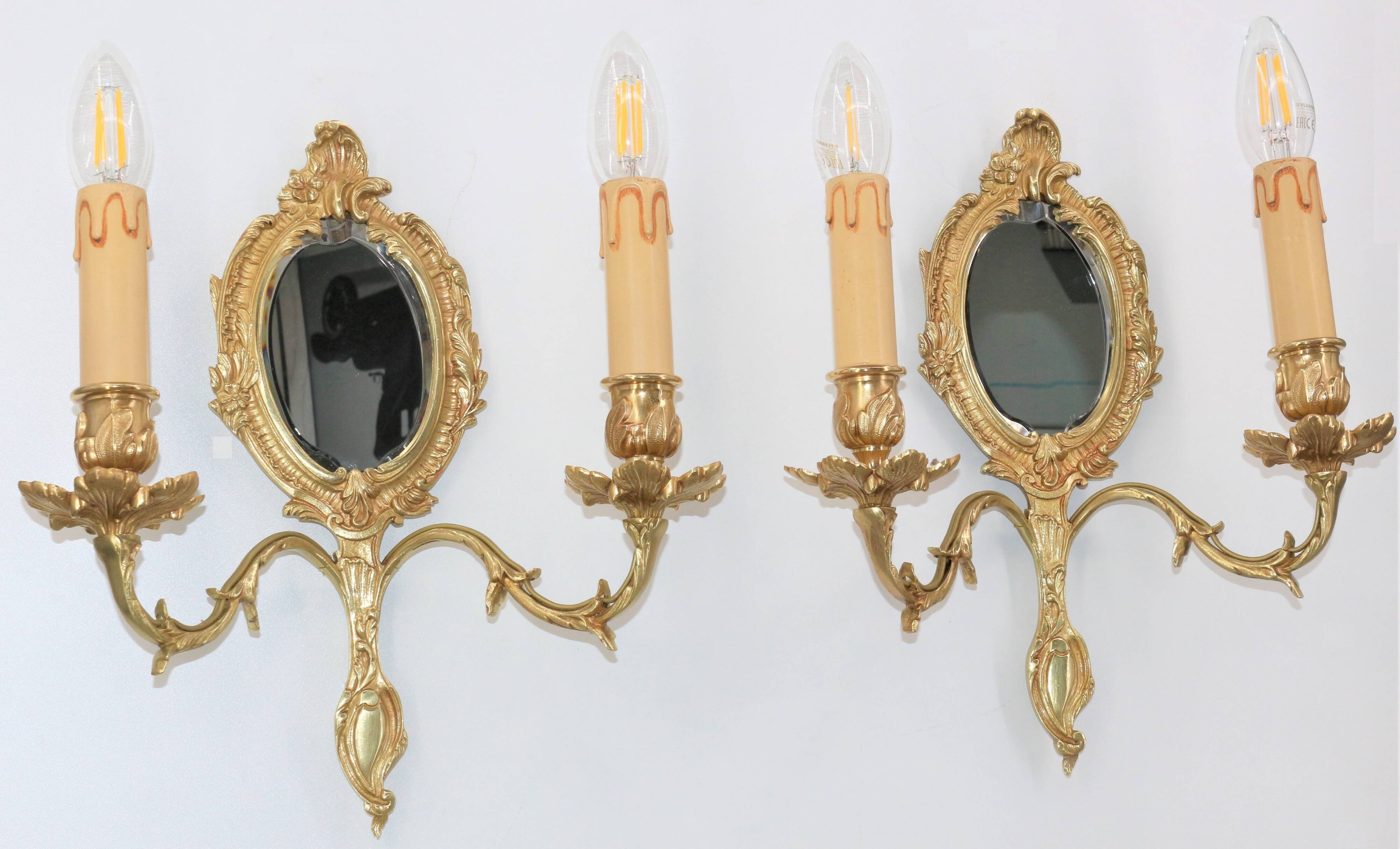 Pair of Louis XV style beveled mirror sconces in bronze by Lucien Gau