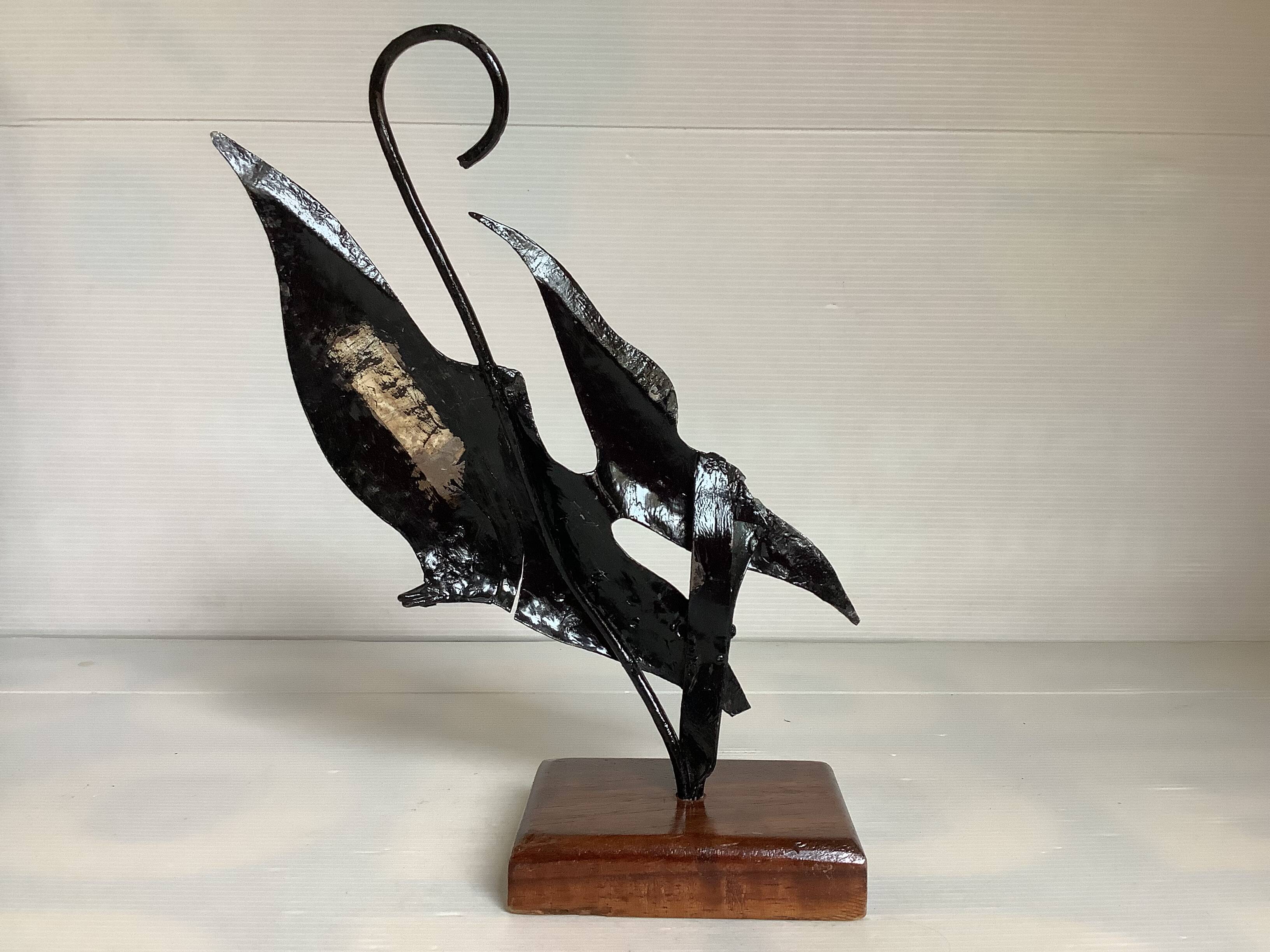Small metal and wood fish statue