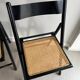 Vintage folding chairs in black wood and cane.