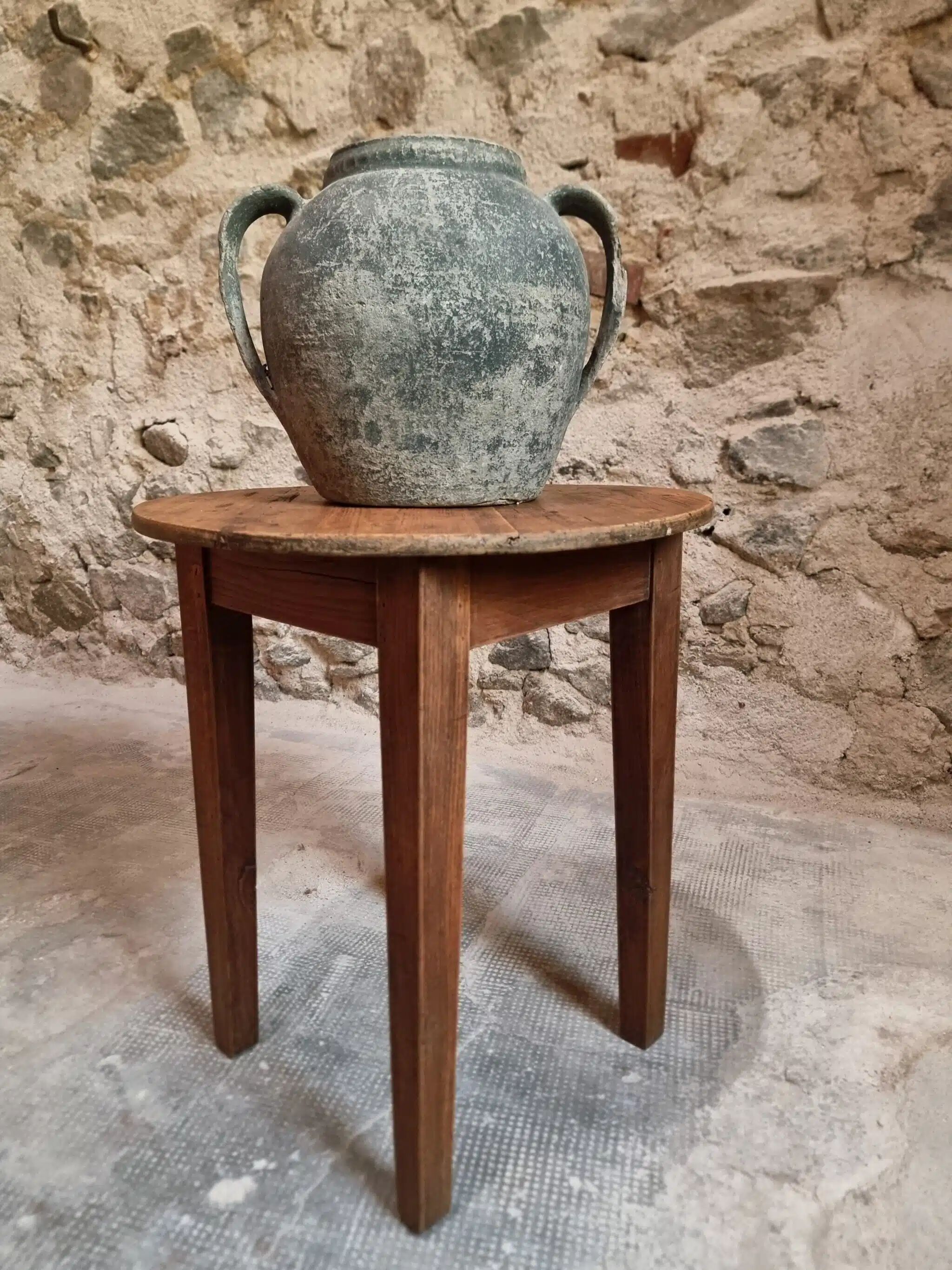 Antique round side table with oak legs and a pine top, circa 1900.