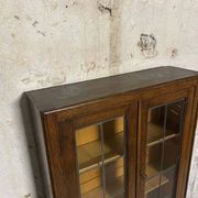 Oak display secretary cabinet with drop-down front, two sections.