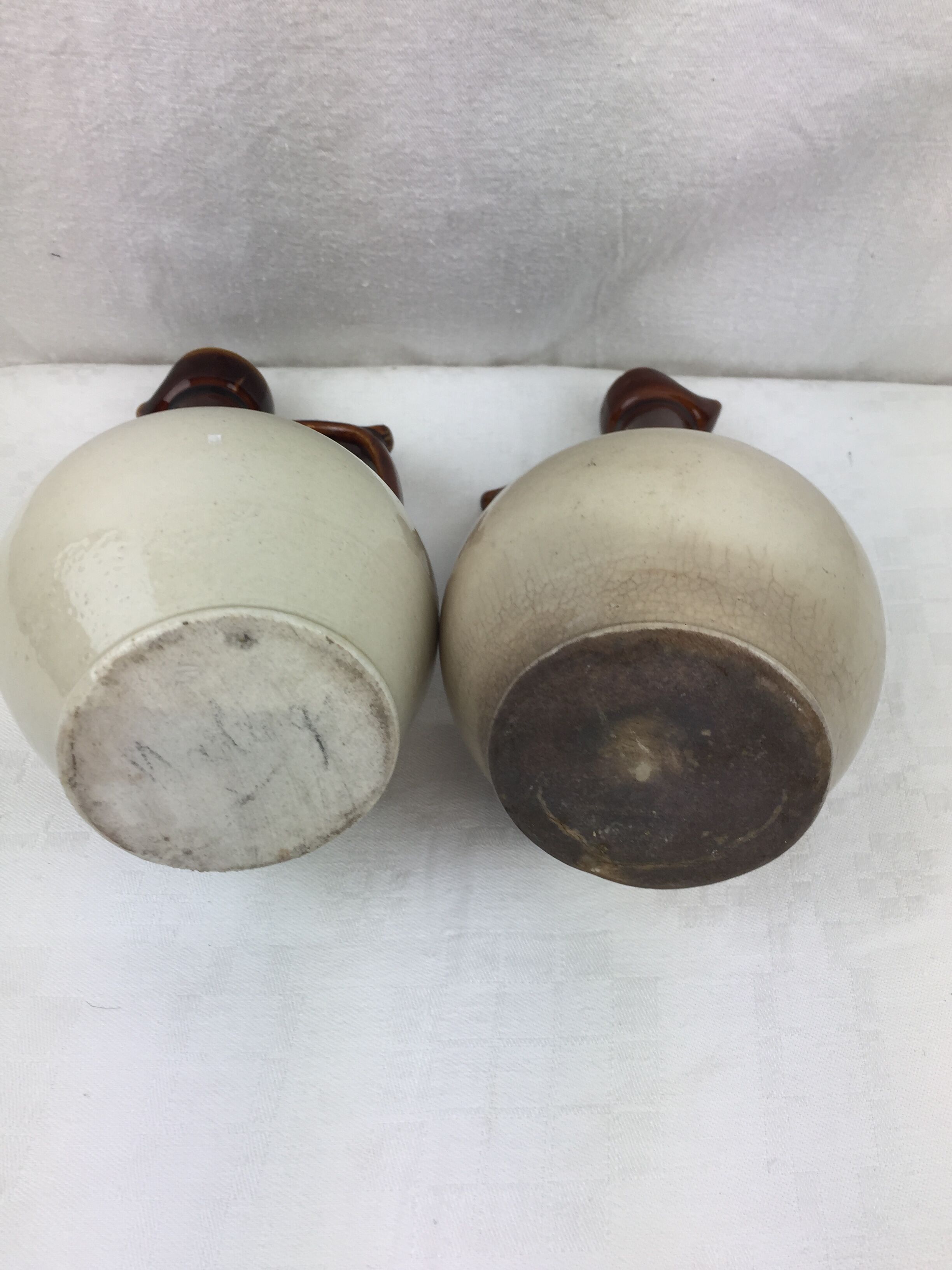 Antique handmade pitchers in beige and brown enamelled terracotta