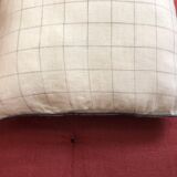 Beige linen cushion with checkered pattern and shiny dark gray piping