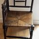 Corner chair made of turned wood with a straw seat.