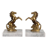 Pair of vintage bookends with rearing horses in gilded metal on marble bases.