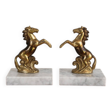 Pair of vintage bookends with rearing horses in gilded metal on marble bases.