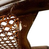 Vintage wooden armchair with rattan weaving.