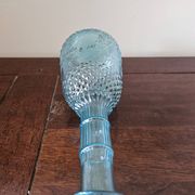 Small vintage turquoise blue glass carafe with floral design.