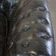 Spacious black cow leather chesterfield armchair with distinctive character