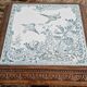 Antique musical trivet made of carved wood and Belle Époque earthenware.