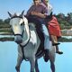 River crossing on horseback, on a sign by Campana.