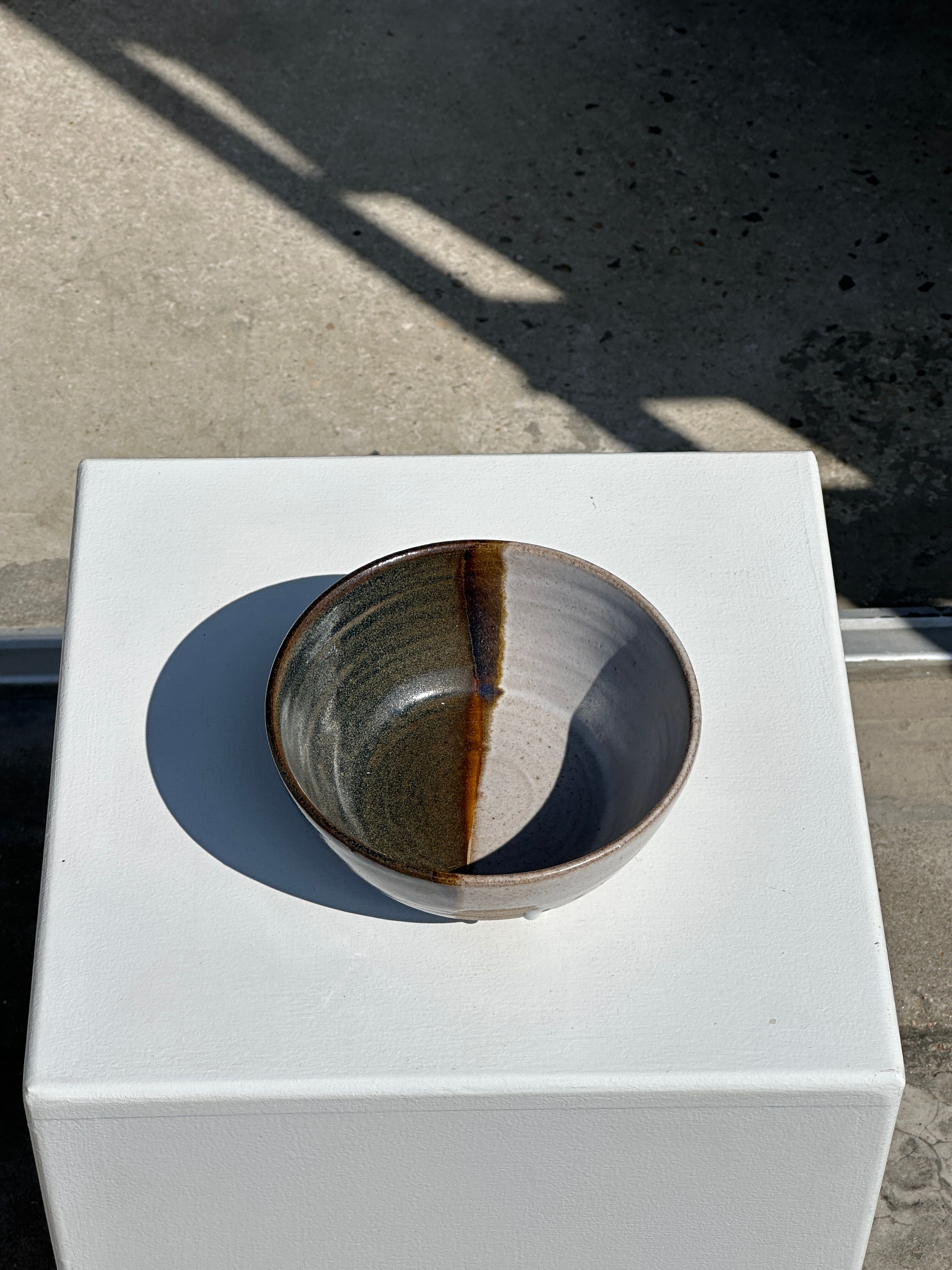 White and glossy brown two-tone ceramic bowl, matt earth