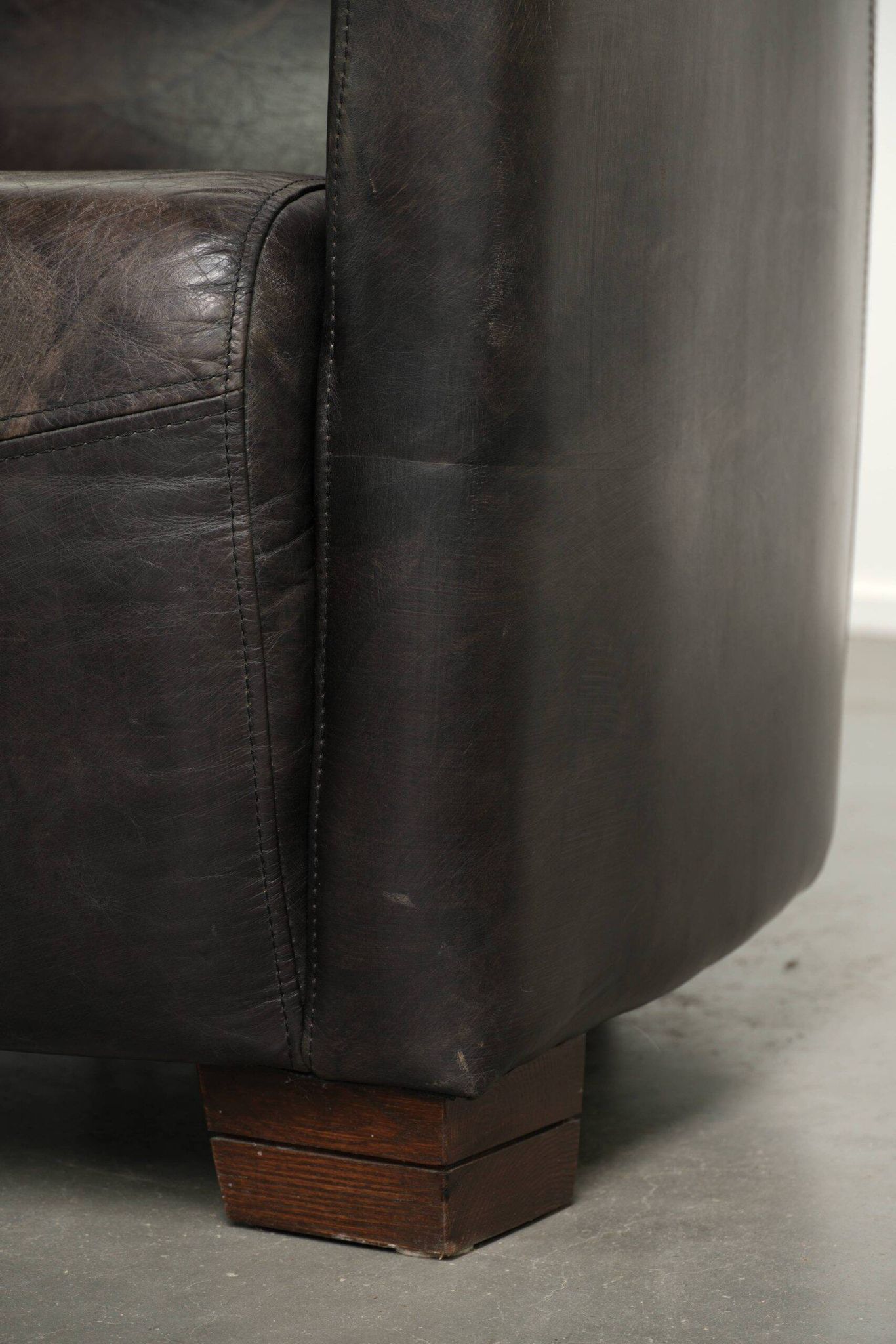 Cow leather Aviator design armchair in a dark colour scheme