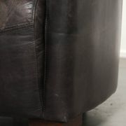 Cow leather Aviator design armchair in a dark colour scheme
