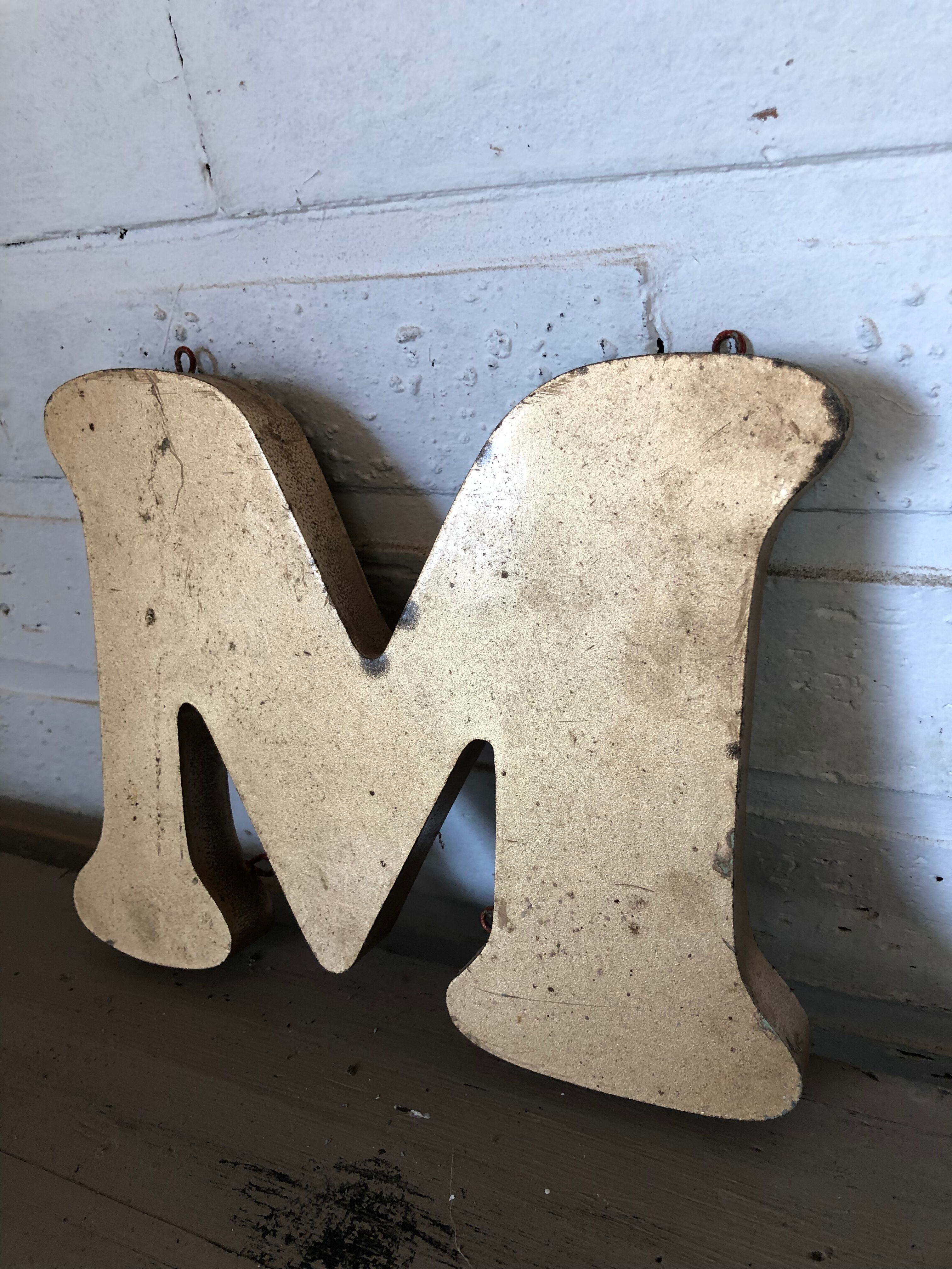 Golden sign letter "M"