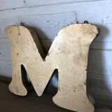 Golden sign letter "M"