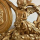 Large antique baroque mirror with angel decorations.