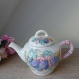 Old ceramic teapot in the shape of a basket of fruits from the garden