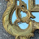 Large mirror with carved and gilded wooden frame, in Regency style.
