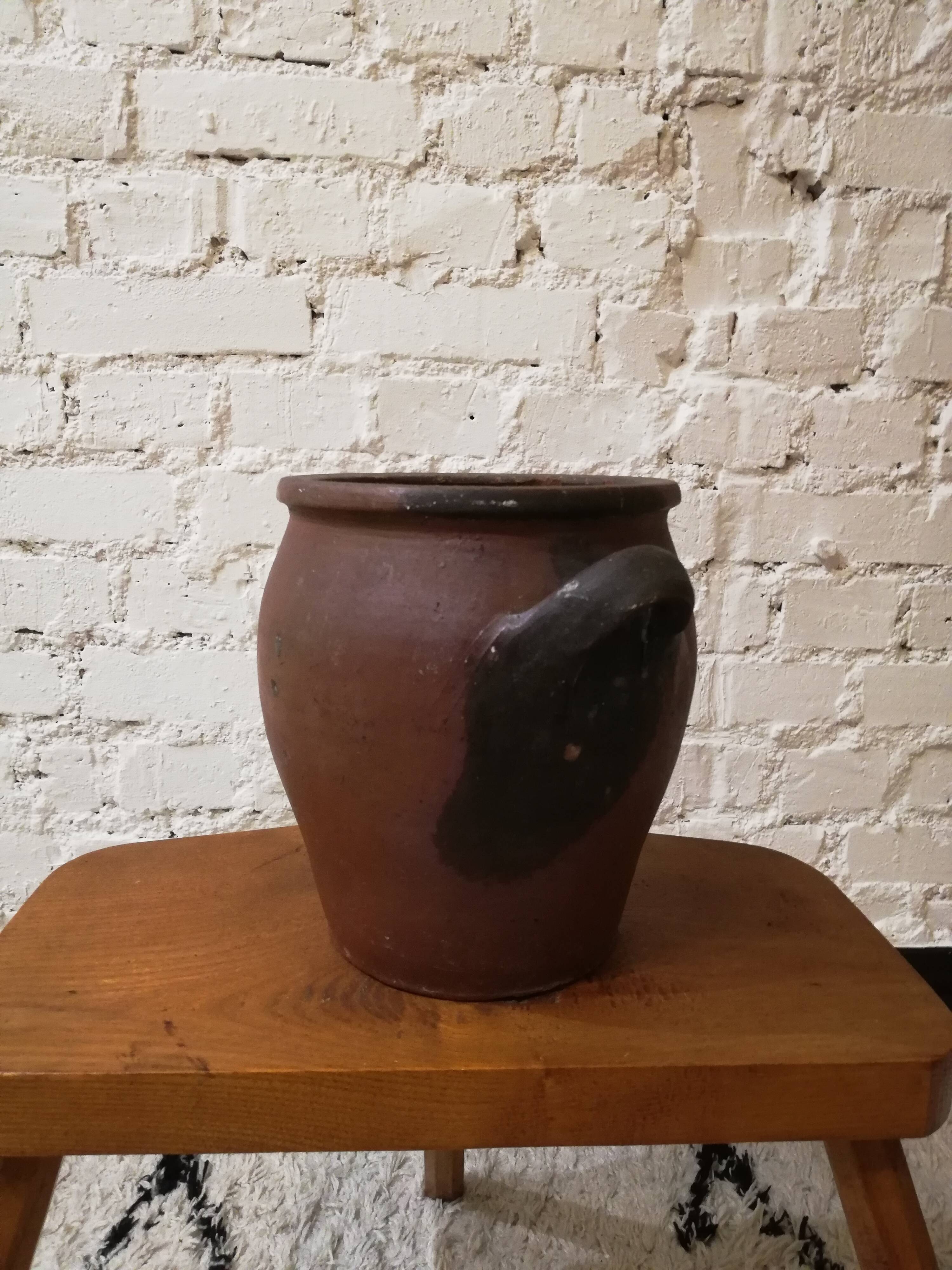 Old red and black terracotta grease pot