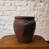 Old red and black terracotta grease pot
