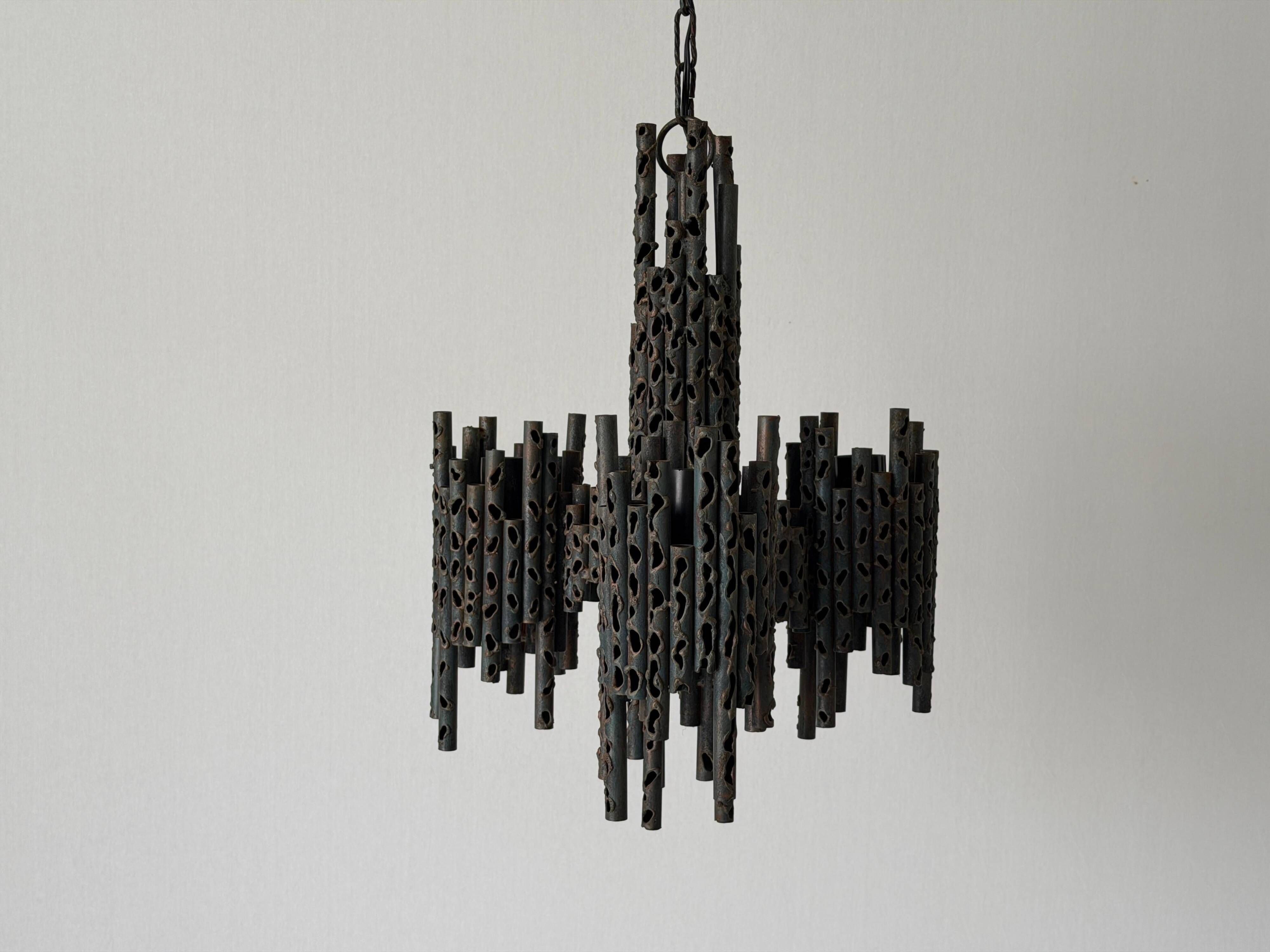 Three-armed suspended lamp in wrought iron, brutalist design, 1960s, Italy.