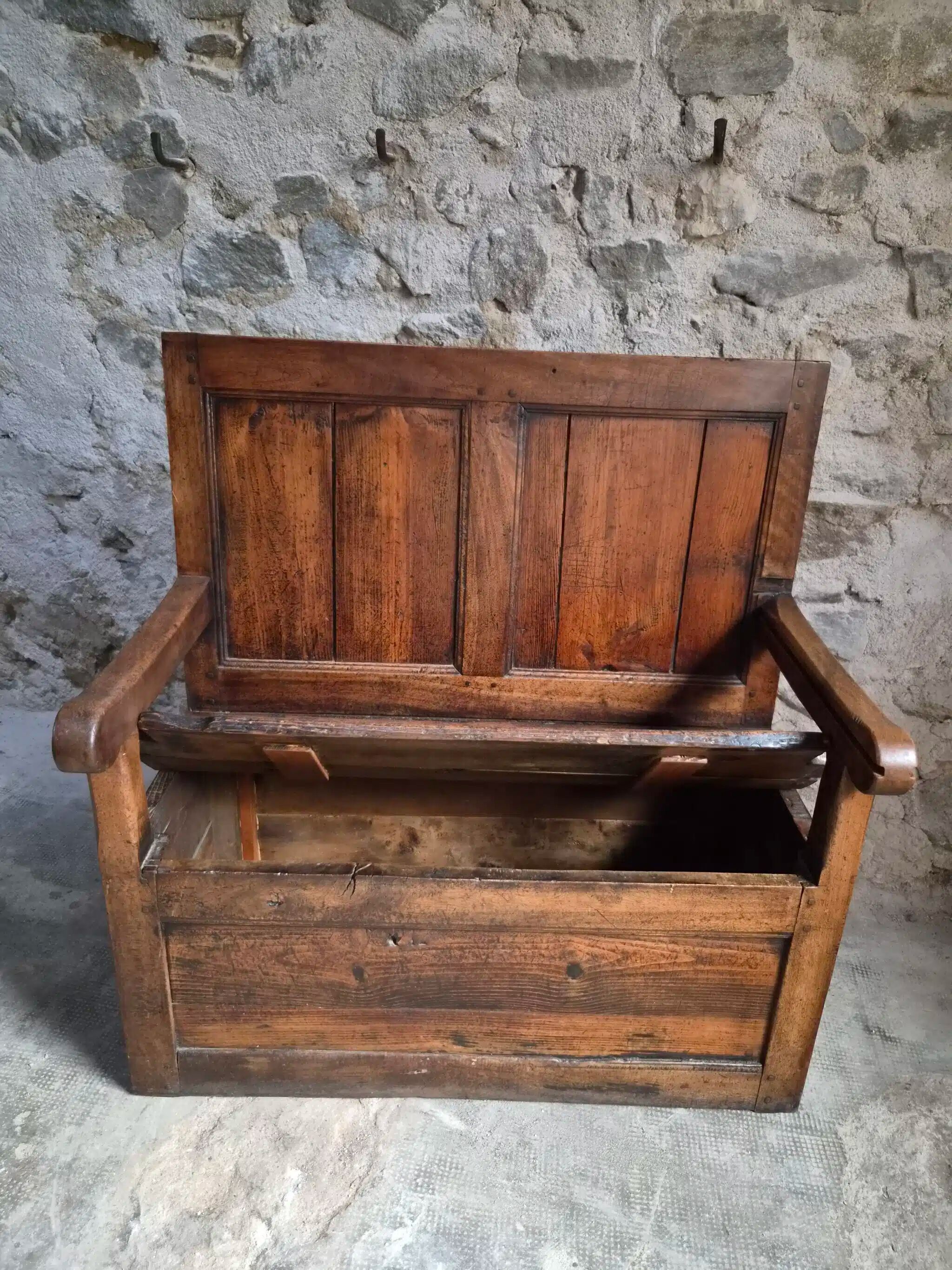 Rustic French antique storage bench from the 18th century in walnut and pine.