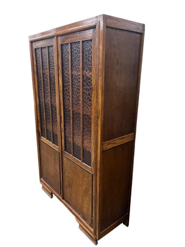Vintage wooden display cabinet with textured glass.