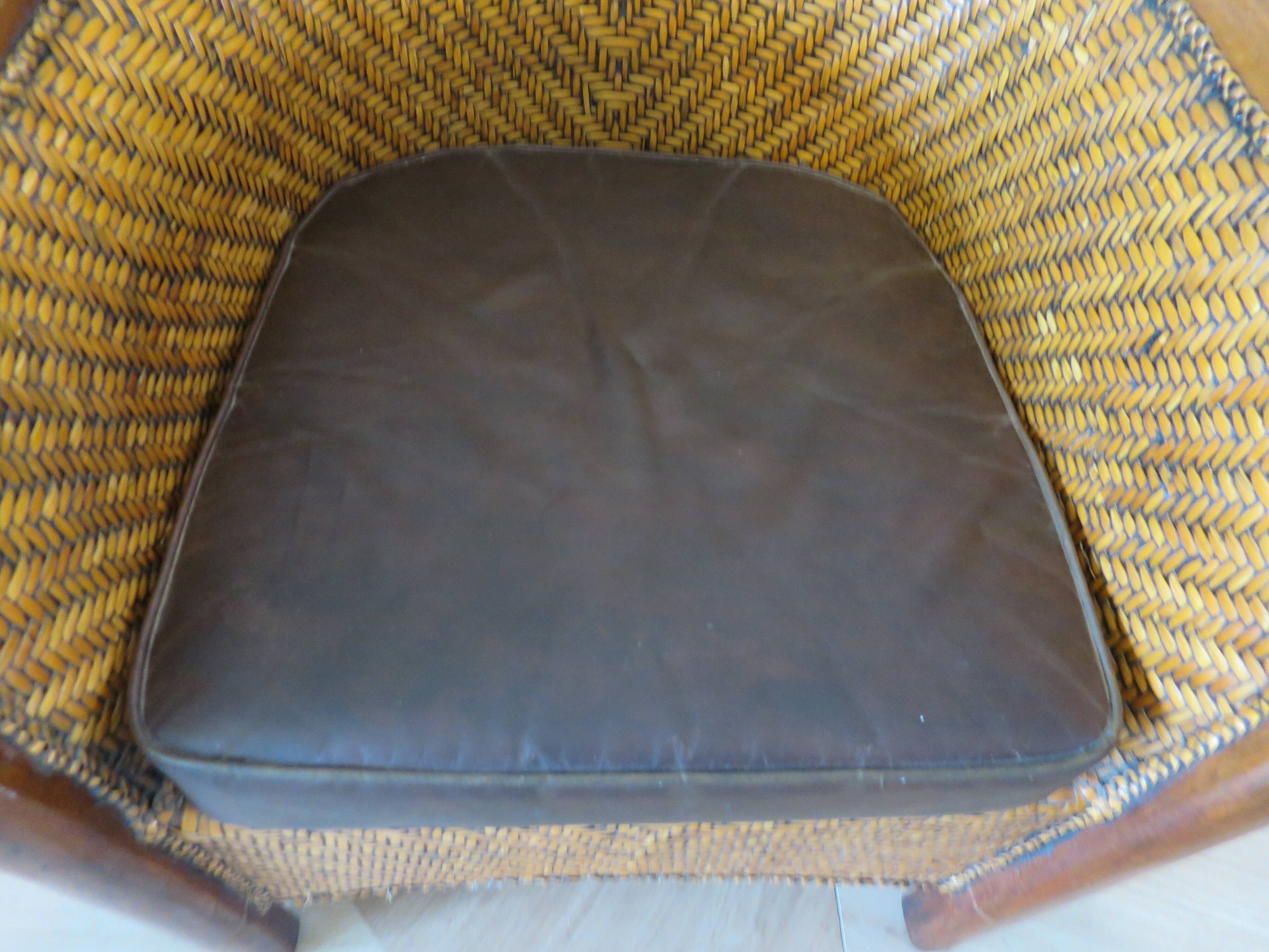 Colonial style armchair in woven rattan and exotic wood