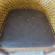 Colonial style armchair in woven rattan and exotic wood