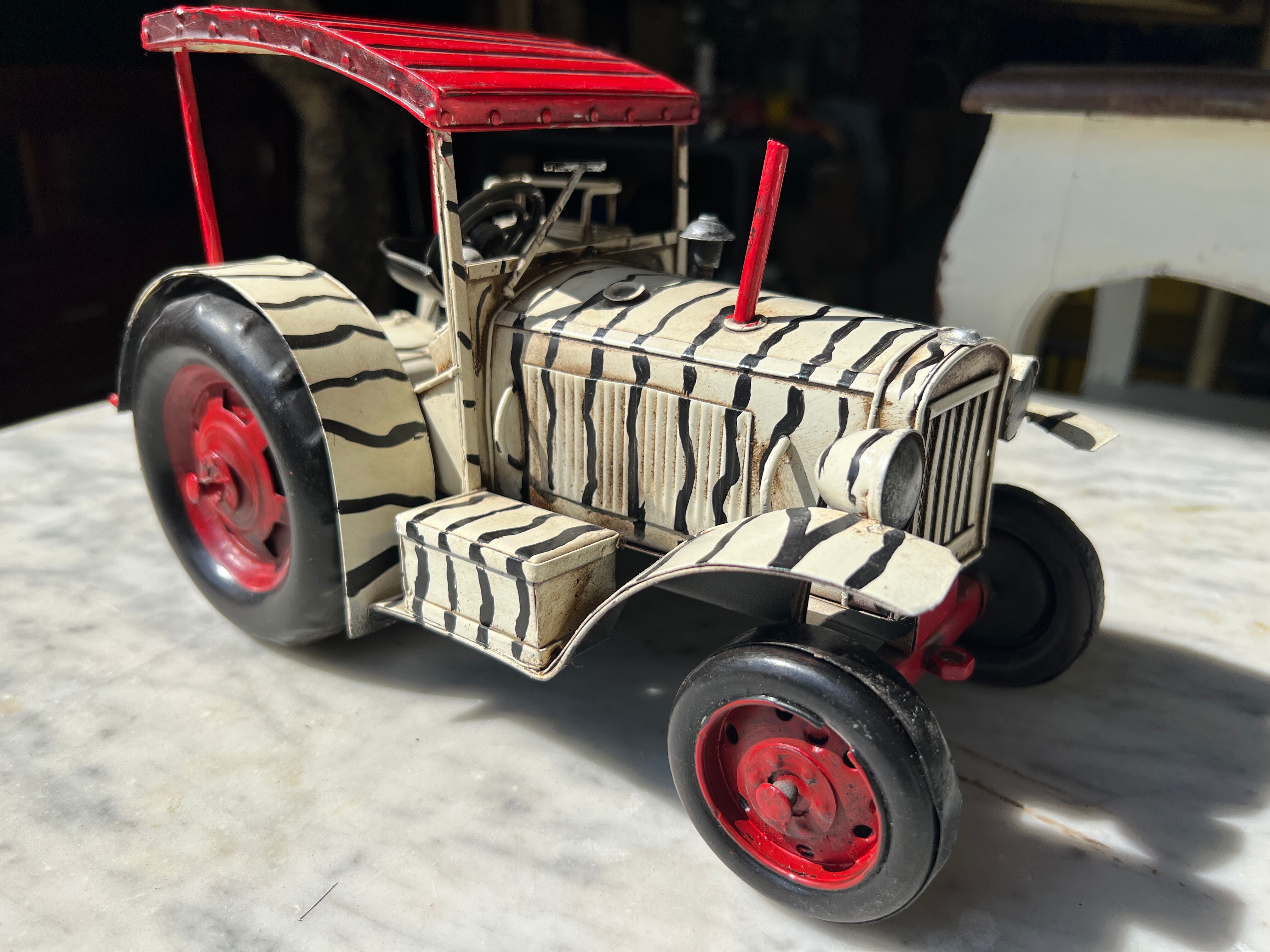 Old zebra metal tractor