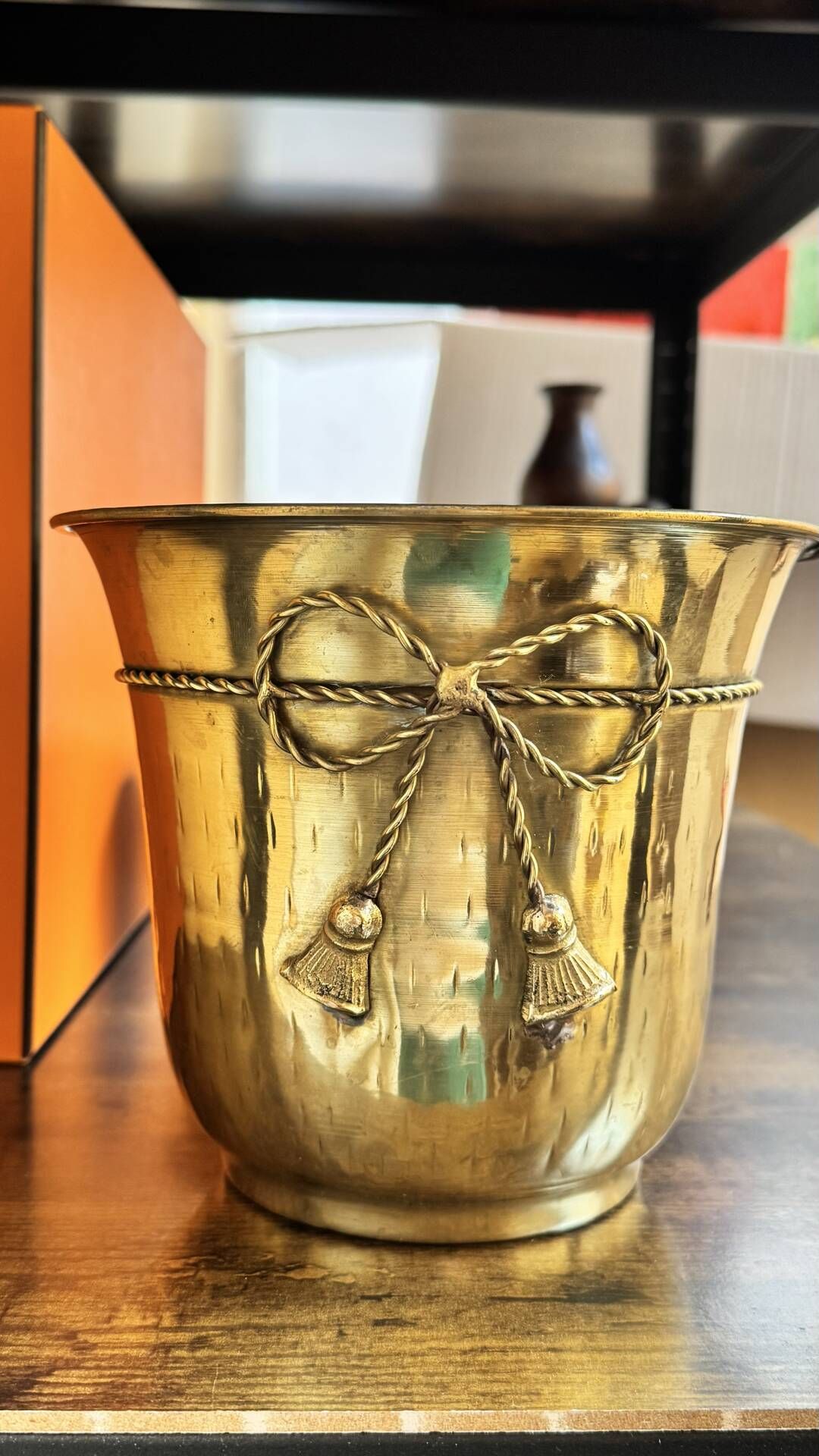 Pair of brass plant pots, decorated with cord and tassels.