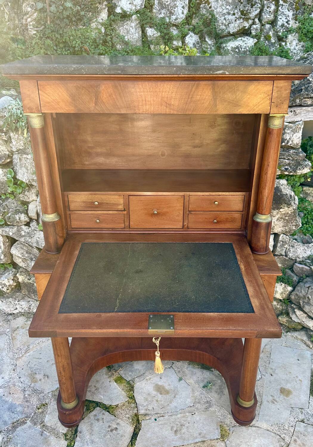 A small piece of Bonheur du jour with detached columns in Empire-era mahogany.