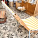 Vintage folding deckchair with yellow striped canvas