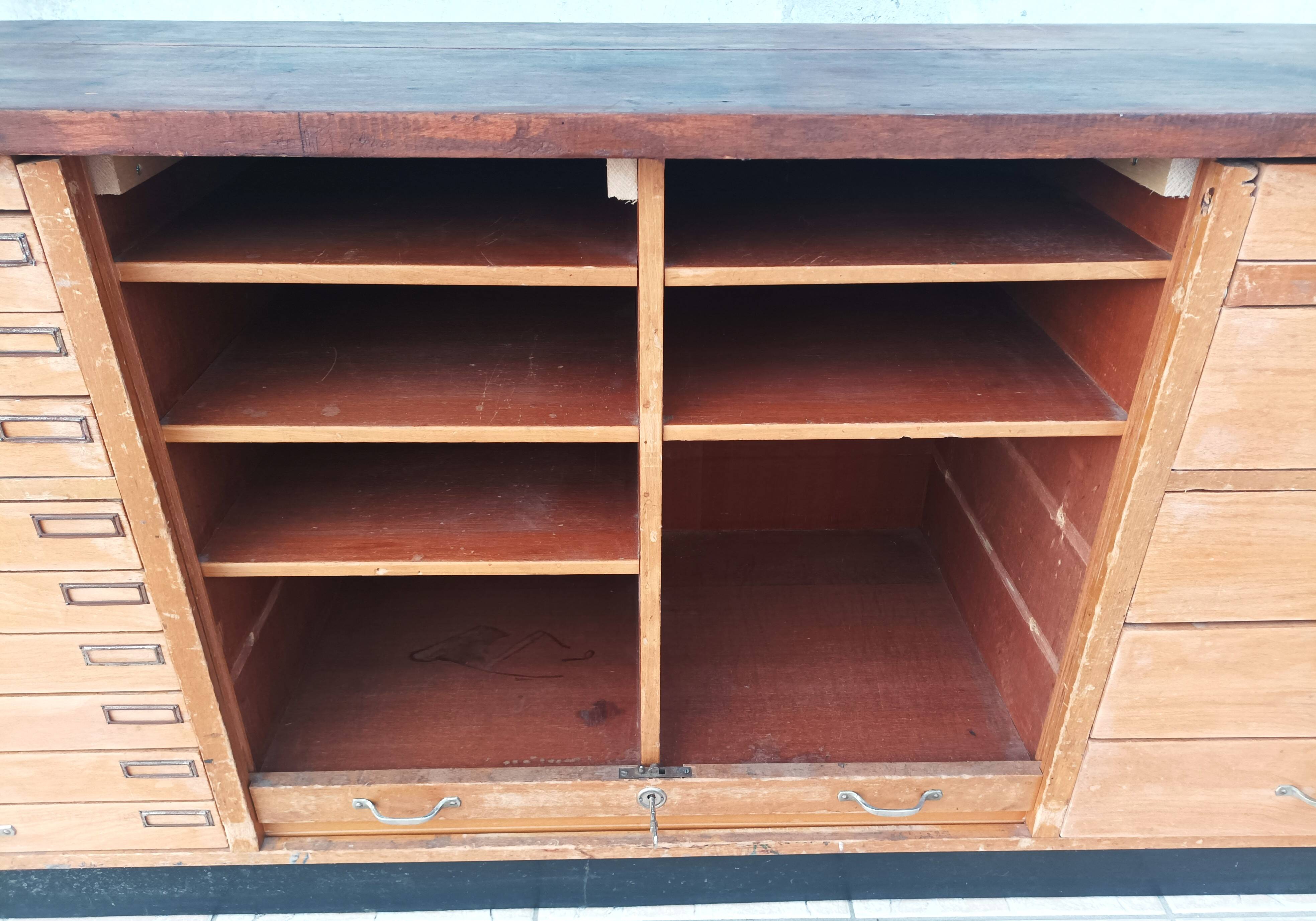 Workshop furniture with drawers and curtain in beech and walnut.